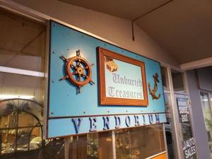 lot 1350 image: LARGE CUSTOM MADE OUTDOOR SIGN IN STYLEDESIGN SHOWN. BUYER IS RESPOSNIBLE FOR BRINGING TOOLS TO REMOVE IT FROM THE FRONT OF THE BUSINESS.