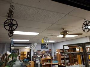 lot 991 image: VINTAGE MOVIE REELS IN VARIOUS STYLESSIZES HANGING FROM CEILING AS SHOWN.