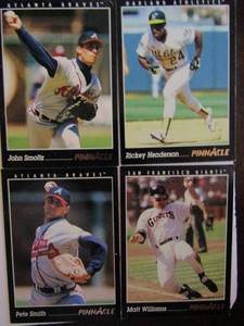 lot 132 image: PINNACLE 1993-#29 Rickey Henderson, #67 Matt Williams, #143 John Smoltz, #541 Pete Smith. Great condition, slight worn edges.