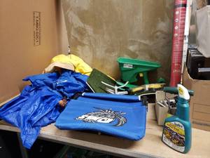 lot 98 image: Gardening and landscaping box including weed barrier, rain gear, bulb planter. insect killer, garden boots, sprinkler, weedeater heads, and much more