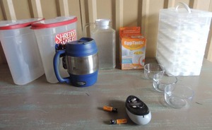 lot 37 image: 2 plastic cereal containers, Bubba Trucker mug, Eggtastic NIB cordless one touch can opener, 5 tray double egg holder