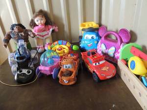 lot 91 image: Renate Cortrall flip car toddler spinning wheel. Mega blocks truck movie cars toy, tow truck Cinderella wagon and more