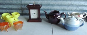lot 100 image: 2 -Footed carnival glass creamer and sugar,  3 yellow cream and sugar set,   Sterling and Noble clock and assorted tea pots