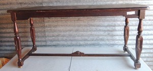 lot 111 image: Dark brown couch table 33x54x17 has minor water damage  bottom of feet