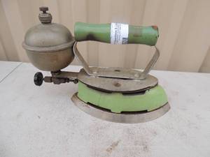 lot 169 image: Metal iron with handle has gassteam chamber marked coleman USA 8x4x6
