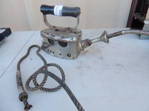 lot 209 image: Cast iron with handle has gas line cord no markings 6x4x7