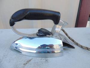 lot 212 image: Metal iron with handle has outlet plug marked general electric hi speed calrod 8x4x5