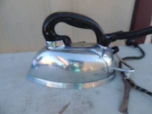 lot 217 image: Metal iron with handle and electric cord marked Silex automatic electric steam iron the Silex co. Hartford. Conn. 115 volt 1000 watt 9x5x6