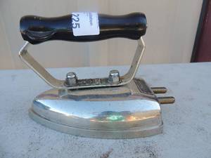lot 225 image: Metal iron with handle marked D Donaldsons safety heating appliances warless iron 250 volt 5 pounds 6x4x5