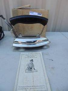lot 379 image: Metal iron with handle and cord  in box has stand plates Westinghouse 250 watts