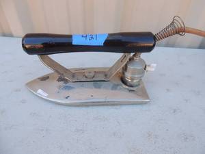lot 421 image: Metal iron with cord Illegible markings