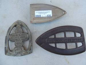 lot 496 image: lot of 3 assorted iron platesstands one marked Cinderella never fail one marked the real gas iron