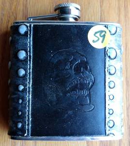 lot 59 image: AWESOME STAINLESS STEEL AND LEATHER BOUND 6 OZ DRINKING FLASK WITH SKULL DESIGN - NEW - RETAIL $22.95