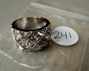lot 241 image: ORNATE SILVER COLORED RING. NO STAMP. APPEARS UNUSED.