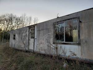 lot 168 image: 40x10 All steel Building on heavy duty 48ft transport plate. This was an old oil drilling site building converted to living quarters not complete. Payment will be due day after close removal by January 15th 2021