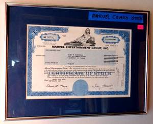 lot 4 image: VERY COOL - ORIGINAL 1995 MARVEL ENTERTAINMENT STOCK CERTIFICATE MATTED AND FRAMED UNDER GLASS. EST $100-$200 measures 12 x 16 framed