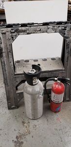 lot 215 image: CO2 Tank (Partially Full), Fire Extinguisher and Plastic Saw Horse