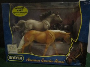 lot 29 image: Breyer American quarter horse #750802  blue gold gold contains 3 horses NEW gray stallion Palamino mare and foal