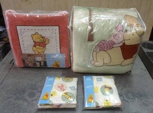 lot 55 image: Disney Winnie the Pooh crib bedding set and accessories.  Includes Bedding set, 3 wall hangings and 2 crib sheets.