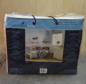 lot 63 image: Nautica 4-piece crib bedding set.  Never opened.