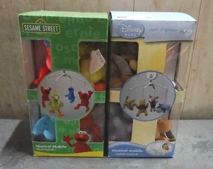 lot 90 image: Sesame Street and Winnie the Pooh musical mobiles.  Quantity of 2.  Never opened.