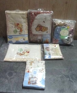 lot 93 image: Disney Winnie the Pooh crib bedding and nursery accessories.  Quantity of 7.  Never opened.