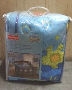 lot 102 image: Fisher-Price Ocean Wonders Deep Blue Sea 4-piece crib bedding set.  Never opened.