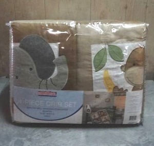 lot 104 image: Bedtime Originals Baby Zoo 4-piece crib bedding set.  Never opened.