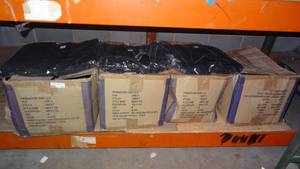 lot 118 image: Solid black 100% regenerated cotton t-shirts in packaging. 4 boxes. Packaging states 72 per box.