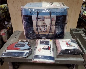 lot 45 image: Nautica baby bedding and accessories. Includes 4-pc bedding set, decorative pillow, wall hangings & diaper stacker. Never opened.