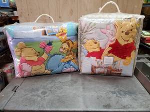lot 53 image: Disney Winnie the Pooh 4-piece crib bedding sets.  Quantity of 2.  Never opened.
