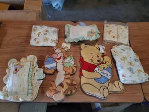 lot 144 image: Winnie the Pooh nursery decor.  Includes wall decor, pillows and bedding