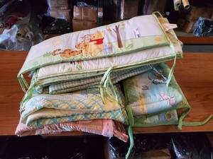 lot 145 image: Winnie the Pooh crib bedding accessories.  Includes quilts and bumper sets.