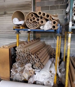 lot 260 image: Cardboard tubes and fabric rolls. Racks not included.