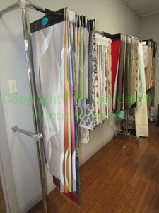 lot 626 image: Assorted fabric samples and wall mount rack, tallest 76 x 61