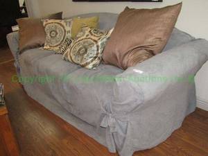 lot 617 image: Loveseat with cover and throw pillows