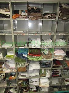 lot 446 image: Assorted fabric samples and remnants contents of shelving unit. Shelving unit not included