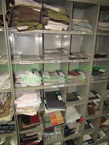 lot 444 image: Assorted fabric samples and remnants contents of shelving unit. Shelving unit not included
