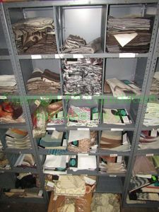 lot 438 image: Assorted fabric samples and remnants contents of shelving unit. Shelving unit not included