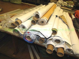 lot 551 image: Large selection of fabric rolls. Generous quantity. Patterns vary. Rack not included.