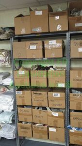 lot 532 image: Assorted fabric samples and remnants contents of shelving unit. Shelving unit not included