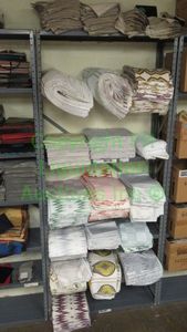lot 534 image: Assorted fabric samples and remnants contents of shelving unit. Shelving unit not included