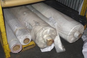 lot 274 image: Rolls of fabric.  Several are full rolls. Patterns vary.