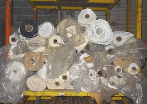 lot 298 image: Large selection of fabric rolls.  Lots of blackout fabric included.  Generous quantity.  Patterns vary.