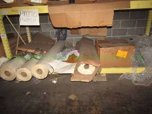 lot 354 image: Contents of bottom shelf.  Includes multi-purpose paper rolls, wire shelf and a box full of tote lids