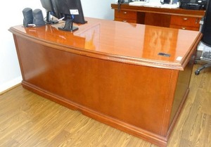 lot 700 image: Wooden bow front executive office desk.  Desk only. Contents not included.  Matches lot 702