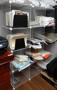lot 703 image: Metal wire shelf w 9 compartments.  Measures 59 x 44 x 15.  Contents not included.