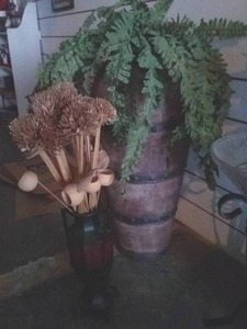 lot 159 image: Metal Tribal Barrel 3ft tall and Metal Vase with Dried Floral Arrangment