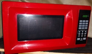 lot 121 image: RED MICROWAVE 700 WATT MODEL EM720CGA-R