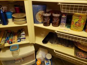 lot 63 image: Contents of Bottom Shelves and Floor Plastic Storage Bin, Metal Tins, Travel Mugs, Stackable Cooling Racks, Freezer Bags and More
